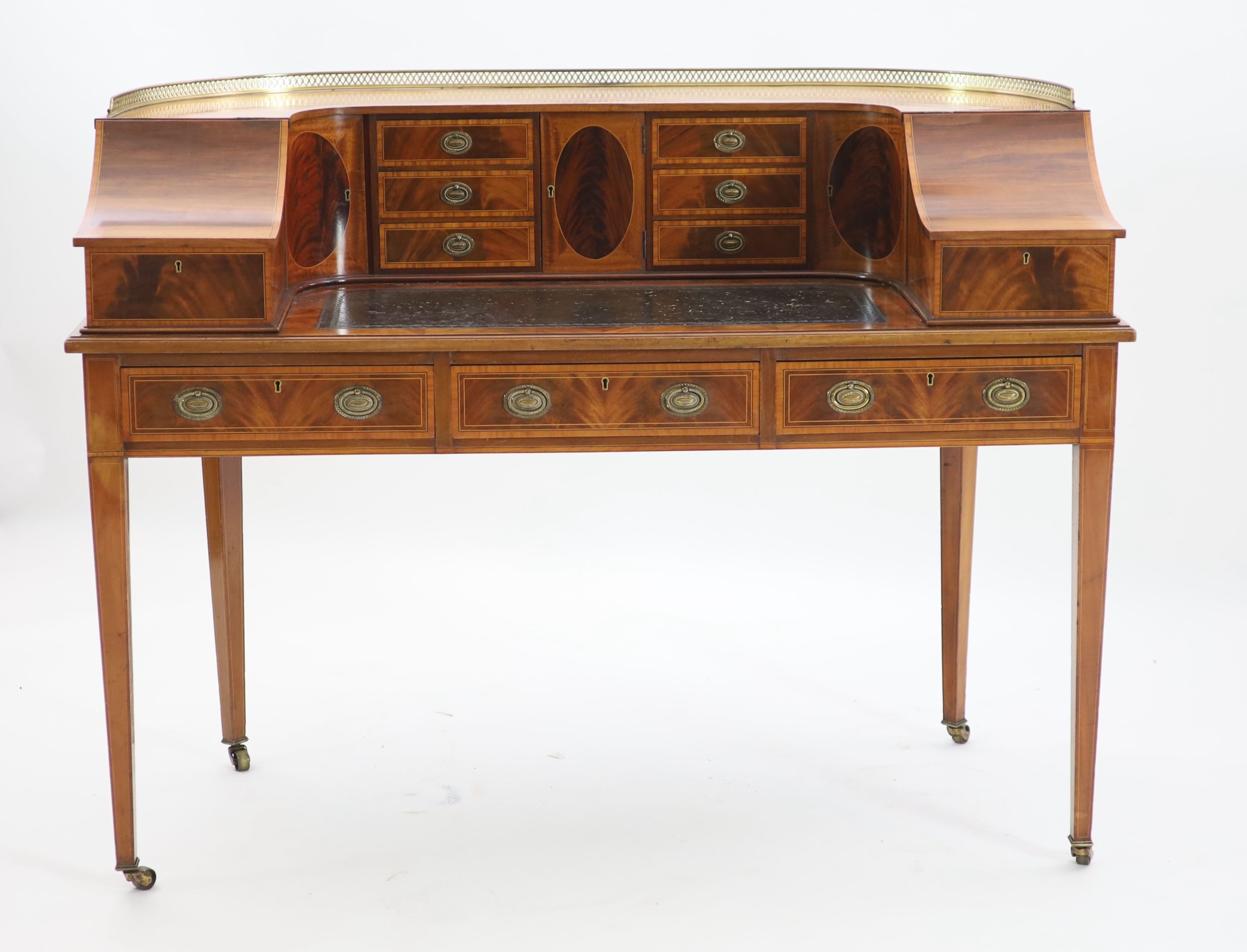 An Edwardian Sheraton revival satinwood banded mahogany Carlton House desk, W.138cm D.65cm H.104cm